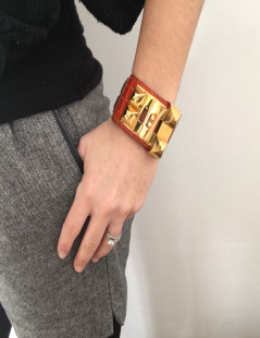 HERMES Medor cuff in orange leather and gold hardware