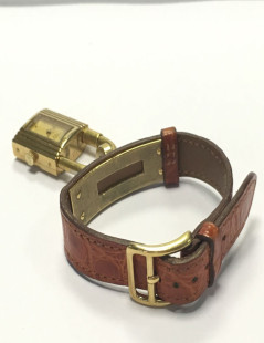 HERMES Kelly watch with ora,ge crocodile bracelet and gilded hardware