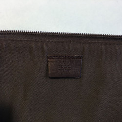 GUCCI monogram embossed brown leather pouch