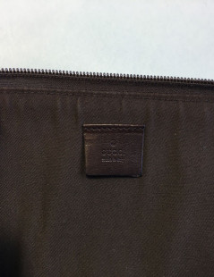 GUCCI monogram embossed brown leather pouch