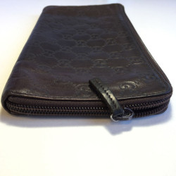 GUCCI monogram embossed brown leather pouch