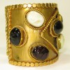 MARGUERITE de VALOIS Couture cuff bracelet in gilt metal and molten glass cabochons