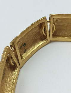 YVES SAINT LAURENT rigid bracelet in gilt metal